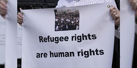 Protestors stand outside The Royal Court of Justice in London,opposing the Home Office's new asylum deal with Rwanda. Friday, June 10, 2022.(Photo |AP)