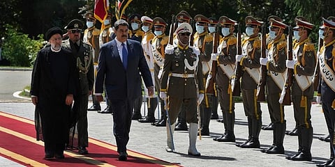 Venezuela's President Nicolas Maduro, third left, reviews an honor guard as he is accompanied by his Iranian counterpart Ebrahim Raisi, left, during his official welcoming ceremony (Photo | AP)