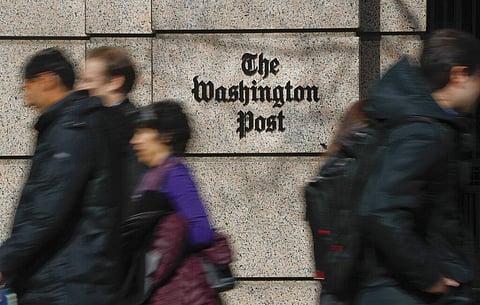 People walk by the One Franklin Square Building, home of The Washington Post newspaper, in downtown Washington. (Photo | AP)
