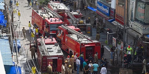 Fire tenders and firefighters at the site after fire broke out at Gaffar market, at Karol Bagh in New Delhi. (Photo | PTI)