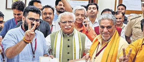 Haryana CM Manohar Lal Khattar with winning candidate Krishan Lal Panwar and Kartikeya Sharma. (Photo | PTI)