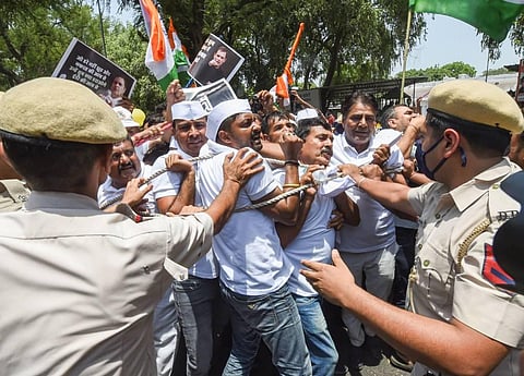 Police detain Youth Congress workers during a protest outside the AICC office against summoning of party leader Rahul Gandhi by the Enforcement Directorate (ED). (Photo | PTI)