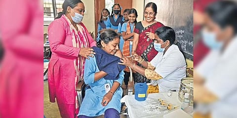 A health worker administers the Covid-19vaccine to a student at a government school in Bengaluru on Tuesday | Vinod Kumar T