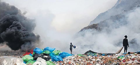 People try to douse the fire which broke out at Bhalswa landfill on Friday. (Photo | Shekhar Yadav, EPS)