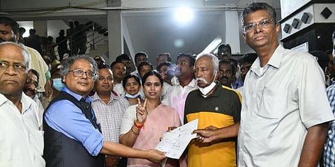 Prakash Hukkeri of Congress receiving the official certificate from Returning Officer and also Regional Commissioner Amlan Aditya Biswas after his victory in Belagavi on Wednesday.