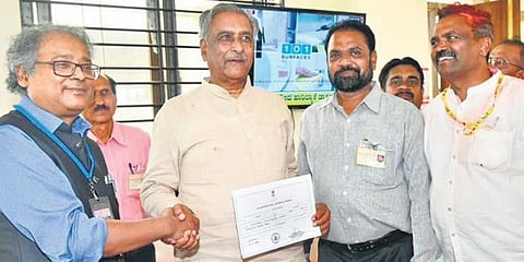 MLC Basavaraj Horatti receives the official certificate from Returning Officer Amlan Aditya Biswas after his victory in Belagavi on Wednesday | Express 