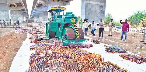 Prakasam police and SEB officials destroying illegal liquor worth `2.14 crore under the NH-16 flyover in Ongole. (Photo| EPS)