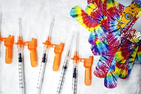 Syringes and colorful bandages are prepared as children from local schools prepare to get COVID-19 vaccines in Pittsfield, Massachusetts. (Photo | AP)