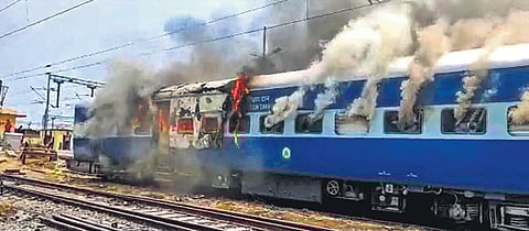 Smoke billows out from a train after it was set on fire by protesters opposing ‘Agnipath’ in Chapra in Bihar on Thursday | PTI