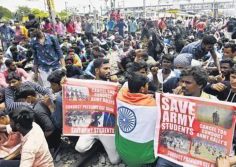 Protesters hold banners demanding the withdrawal of the scheme while squatting on the tracks |VINAY MADAPU