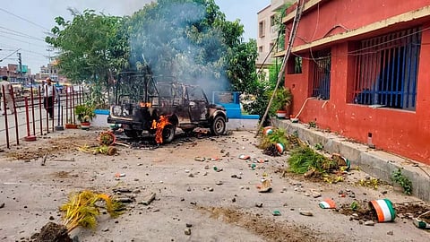 A vehicle after it was set on fire by protestors during the Bihar Bandh, called to protest against Centre's 'Agnipath' scheme, in Masaurhi. (Photo | PTI)