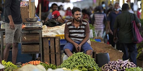 A vender waits for customers at a vegetable market place in Colombo, Sri Lanka, Friday, June 10, 2022. (Photo | AP)