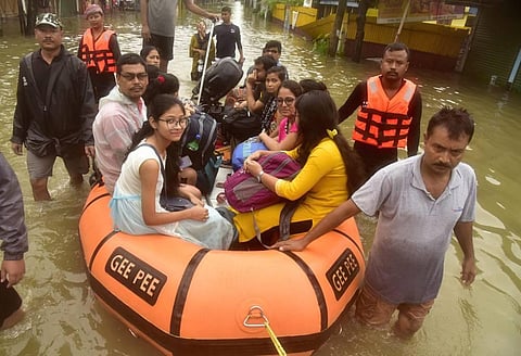 State Disaster Response Force (SDRF) shift flood-affected people in Bajali district of Assam, Friday, June 17, 2022. (Photo | PTI)