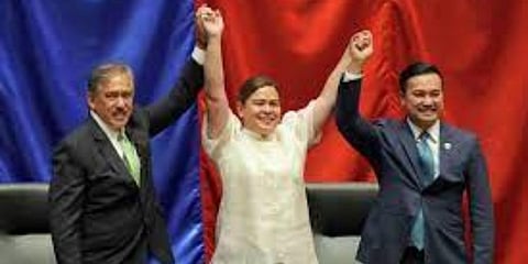 Vice-president-elect Sara Duterte (center) raises hands with Senate President Vicente Sotto III (left) and House Speaker Lord Allan Velasco during her proclamation, on June 19. (Photo| AP)