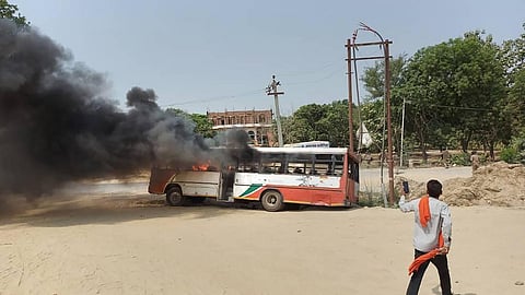 A bus that was set ablaze by Anti-Agnipath protestors, in Jaunpur, Saturday, June 18, 2022. (Photo | PTI)