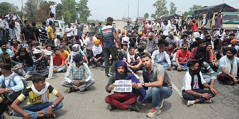 Youngsters stage a protest against the newly announced Agnipath scheme, at Jalandhar-Delhi national highway. (Photo | PTI)