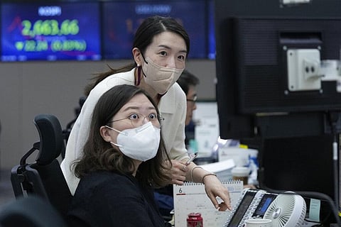 Currency traders watch monitors at the foreign exchange dealing room of the KEB Hana Bank headquarters in Seoul, South Korea, Thursday, June 2, 2022.(Photo | AP)
