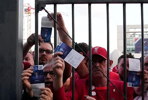 Fans shows tickets in front of the Stade de France prior the Champions League final soccer match between Liverpool and Real Madrid, in Saint Denis near Paris. (Photo | AP)