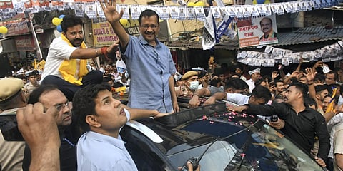 Delhi Chief Minister and AAP Convener Arvind Kejriwal waves at the supporters during a roadshow for Rajinder Nagar assembly constituency by-elections, at Inder Puri in New Delhi. (Photo| PTI)