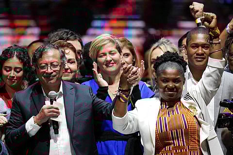Former rebel Gustavo Petro, left, his wife Veronica Alcocer, back center, and his running mate Francia Marquez, celebrate before supporters after winning a runoff presidential election. (Photo| AP)