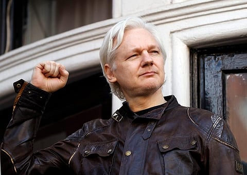 Julian Assange greets supporters. (Photo | AP)