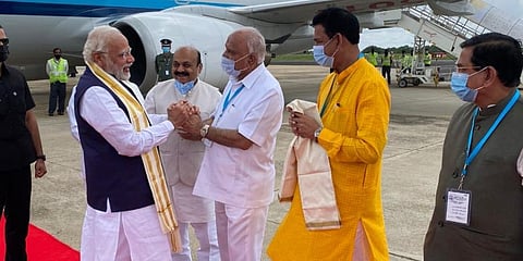 Chief minister Basavaraj Bommai and Governor Thaawarchand Gehlot receiving PM Modi at Yelahanka Airforce Station in Bengaluru. (Photo | Express)