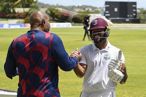 Phil Simmons (L), congratulates John Campbell (R), of West Indies, after winning on the fourth day of the 1st Test between Bangladesh and West Indies. (Photo | AFP)