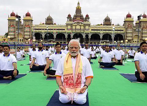 Prime Minister Narendra Modi performs yoga at the main event of the eighth edition of the International Day of Yoga at the Mysore Palace. (Photo | Udayashankar S, EPS)