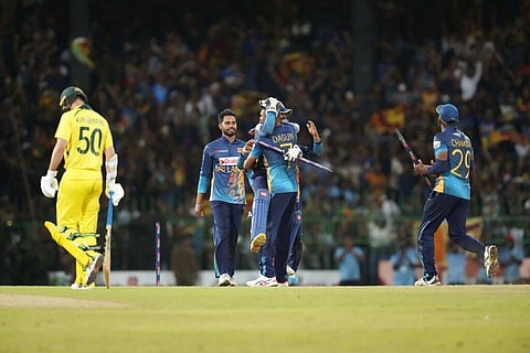 Sri Lanka's captain Dasun Shanaka is hugged by his teammates as they celebrate their team's victory over Australia by four runs in the fourth ODI between Australia and Sri Lanka. (Photo | AP)