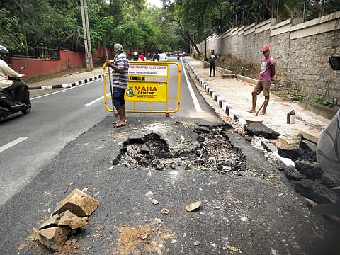 A portion of the newly-relaid Mariyappanapalya Jnana Bharthi main road in Bangalore University campus caved in. (Photo | EPS)