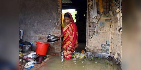 A woman at her flooded house at Nagendra Nagar, in Karimganj district(Photo | PTI)