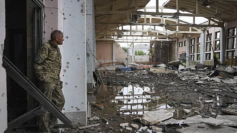 A Ukrainian serviceman looks at the ruins of the sports complex of the National Technical University in Kharkiv, Ukraine. (Photo | AP)