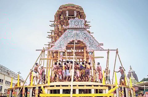 Servitors fixing ‘Chara Mala’ on one of the three chariots in Puri on Friday | Express