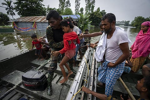 Indian Army personnel rescue flood-affected people on a boat in Tarabari village, west of Guwahati, in the state of Assam, Monday, June 20, 2022. (Photo | AP)