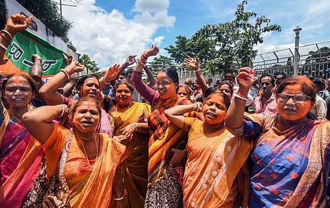 BJP supporters celebrate after Tripura Chief Minister and BJP candidate Manik Saha wins from Town Bardowali seat, during the by-elections, in Agartala. (Photo | PTI)