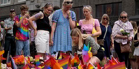 People react as they lay flowers at the scene of a shooting in central Oslo, Norway. (Photo| AP)