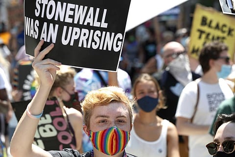 A person holds up a sign referencing the Stonewall Inn, during a queer liberation march for Black Lives Matter and against police brutality, Sunday, June 28, 2020, in New York. (Photo | AP)