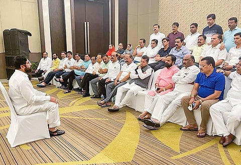 Rebel Shiv Sena leader Eknath Shinde interacts with supporting MLAs at a hotel, in Guwahati. (Photo | PTI)