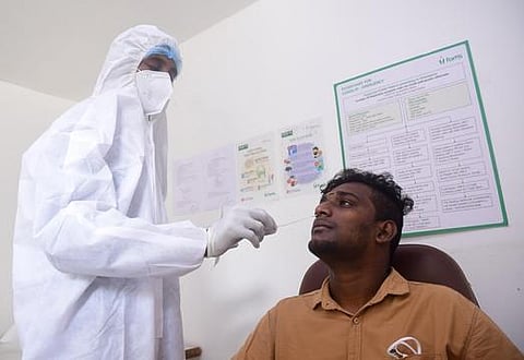 A lab technician collects nasal swab samples for Covid testing. (Photo | EPS)