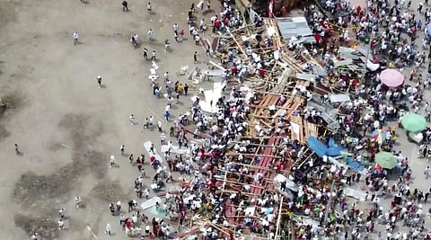 Spectators are sent plunging to the ground as part of a wooden stand collapses during a bullfight at a stadium in the city of El Espinal. (Photo | AP)