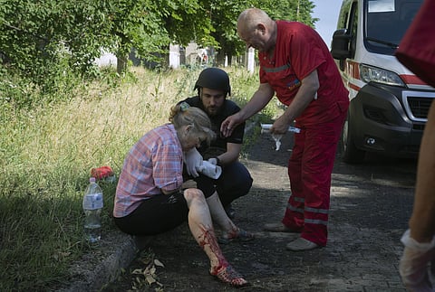 A police officer and paramedic give the first aid to a woman wounded by the Russian shelling in city center in Slavyansk, Donetsk region, Ukraine, Monday, June 27, 2022. (Photo | AP)