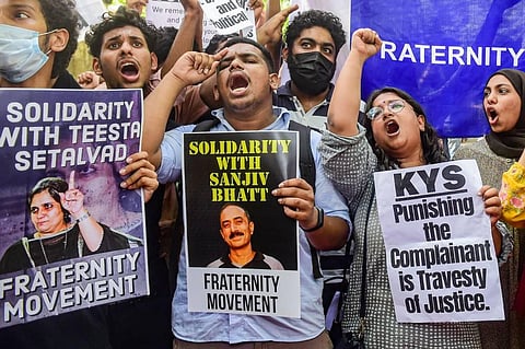 People hold placards and shout slogans during a protest against the arrest of social activist & journalist Teesta Setalvad, former Director-General of Police of Gujarat R.B. Sreekumar. (Photo | PTI)