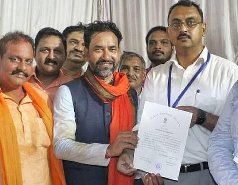 BJP candidate Dinesh Lal Yadav Nirahua receives his 'Certificate of Election' from District Magistrate Vishal Bhardwaj after winning the Azamgarh Lok Sabha by-elections, in Azamgarh. (Photo | PTI)