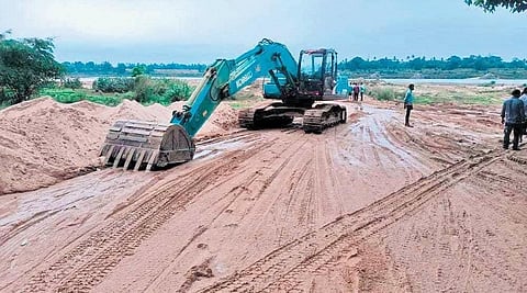 Heavy equipment being used for lifting of sand from a riverbed. (Photo | Express)