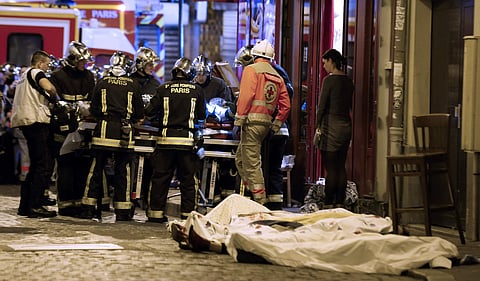 Rescue workers tend to victims outside a cafe in Paris, Nov. 13, 2015.(File Photo | AP)