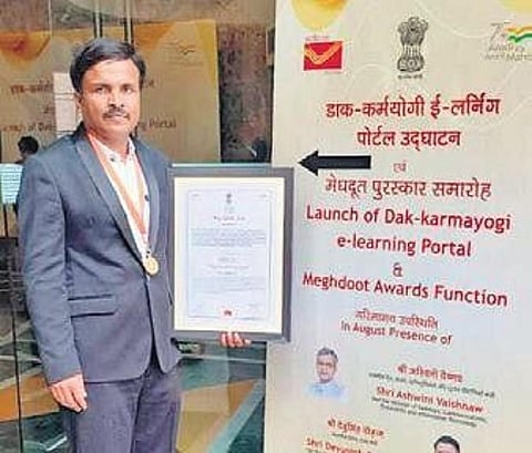 T Dhananjaya, Postal Assistant at the Chief Postal Manager General office in Bengaluru, is overwhelmed by the honour accorded to him. (Photo | Express)