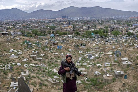 A Taliban fighter poses for a photo at a cemetery in Kabul, Afghanistan, Wednesday, May 4, 2022. (Photo | AP)