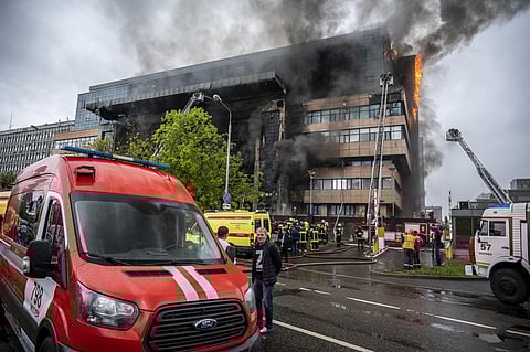 Russian Emergency Situation ministry's firefighters work at the scene of a fire that broke out at a business center in Moscow, Russia. (Photo | AP)