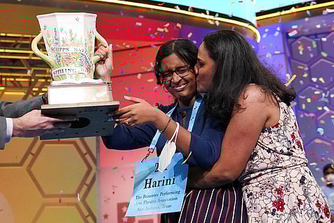 Harini Logan, 14, from San Antonio, Texas, gets a kiss from her mom Rampriya Logan on stage as she celebrates winning the Scripps National Spelling Bee, Thursday, June 2, 2022(Photo | AP)