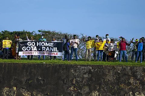Protestors participate in an anti-government demonstration outside the Galle International Cricket Stadium. (Photo | AFP)